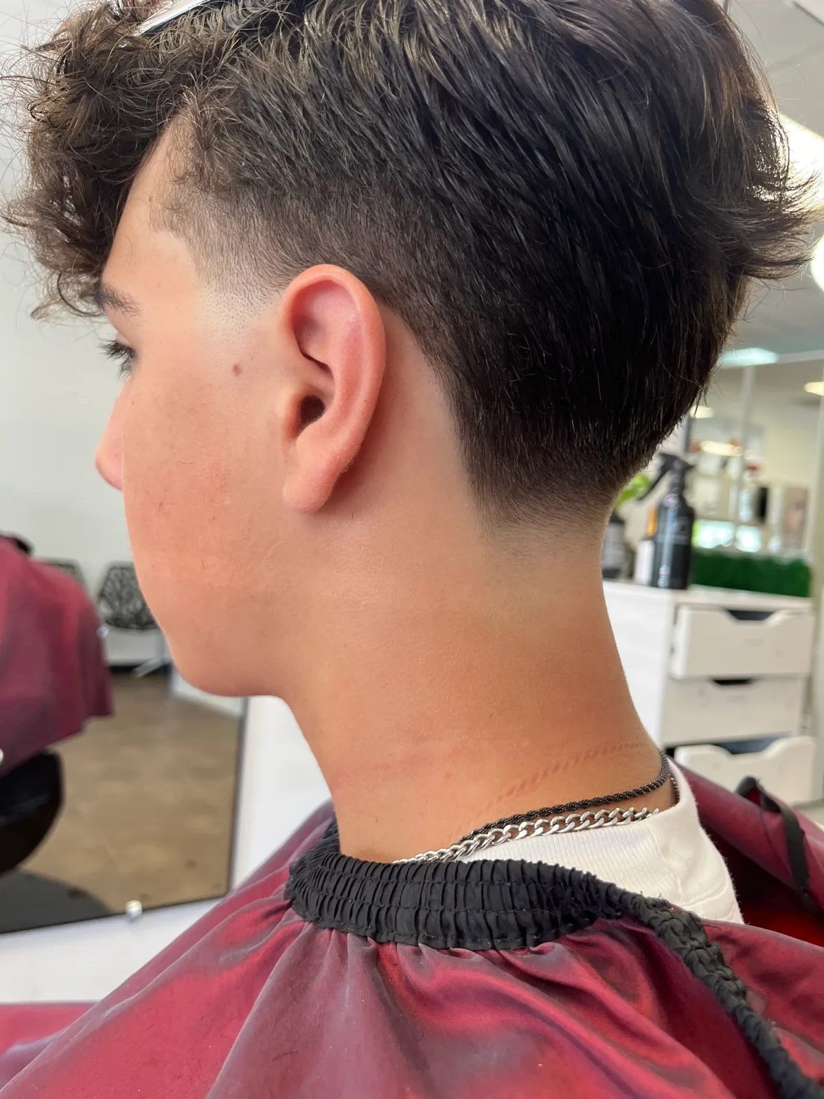 A textured taper with the curl left long on top
