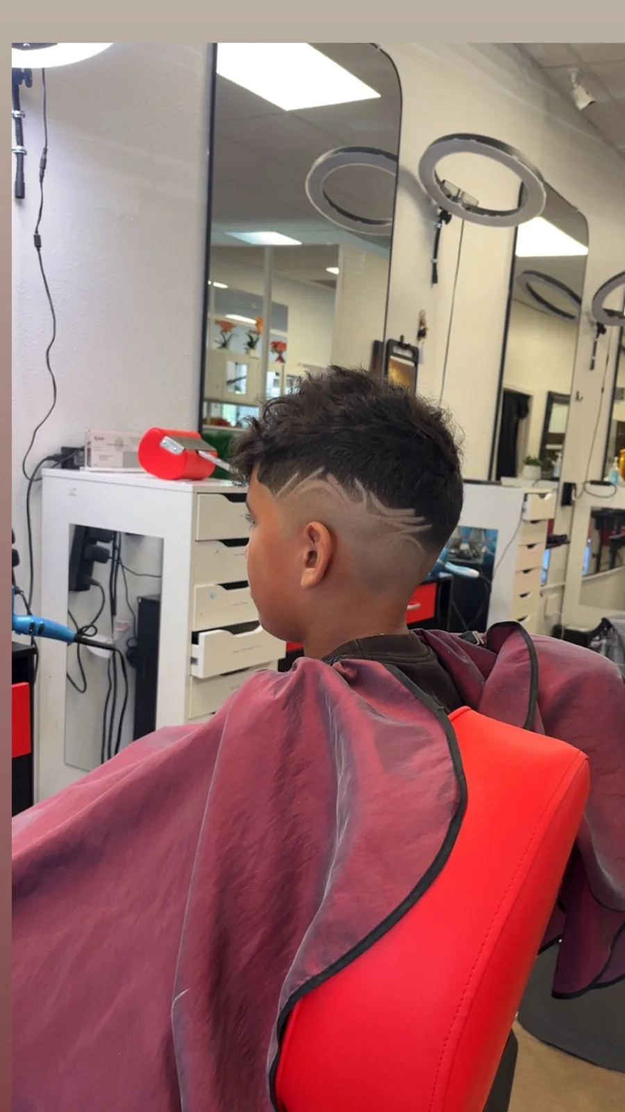 A clean men's fade with a sharp hair design